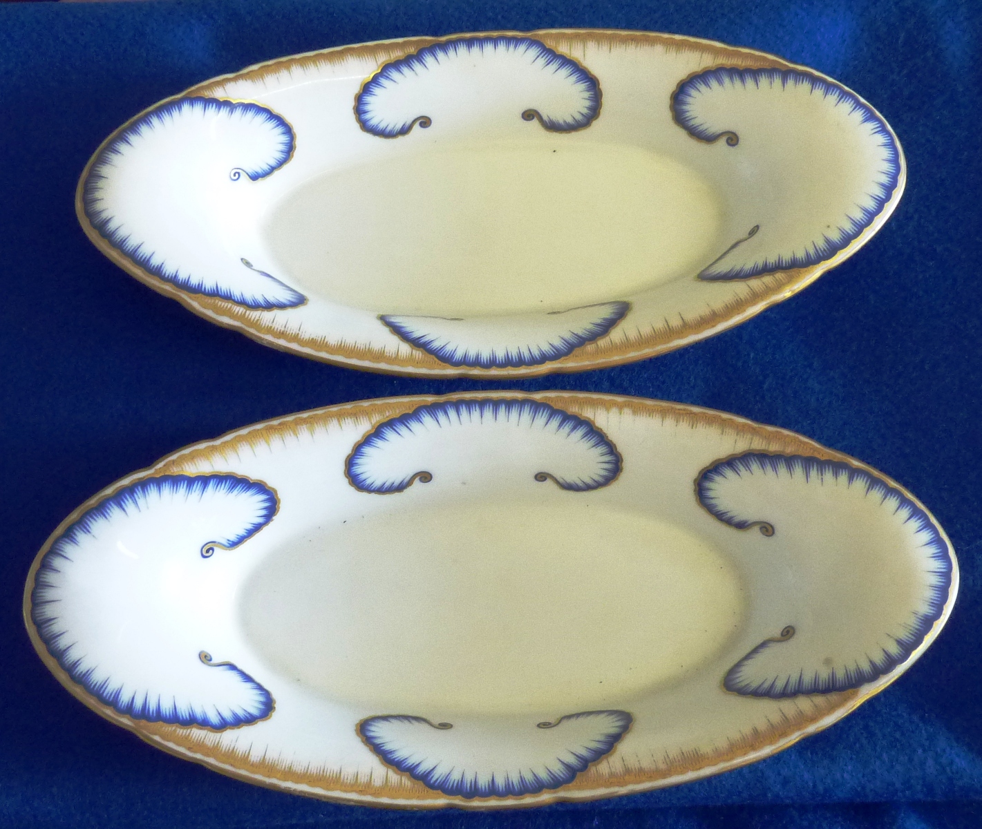 A pair of 19th Century boat shaped porcelain Dishes, each with ornately gilded border and four