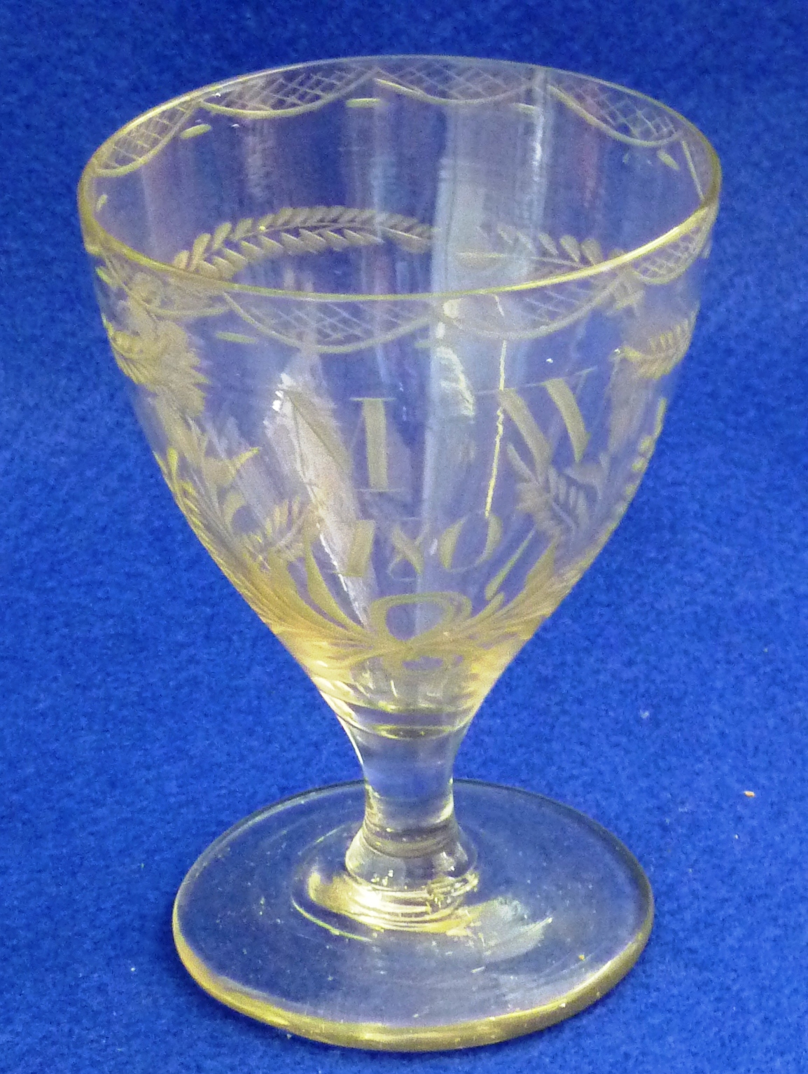 An early 19th Century George III period Wine Glass, the lip decorated with swags above initials M.W.