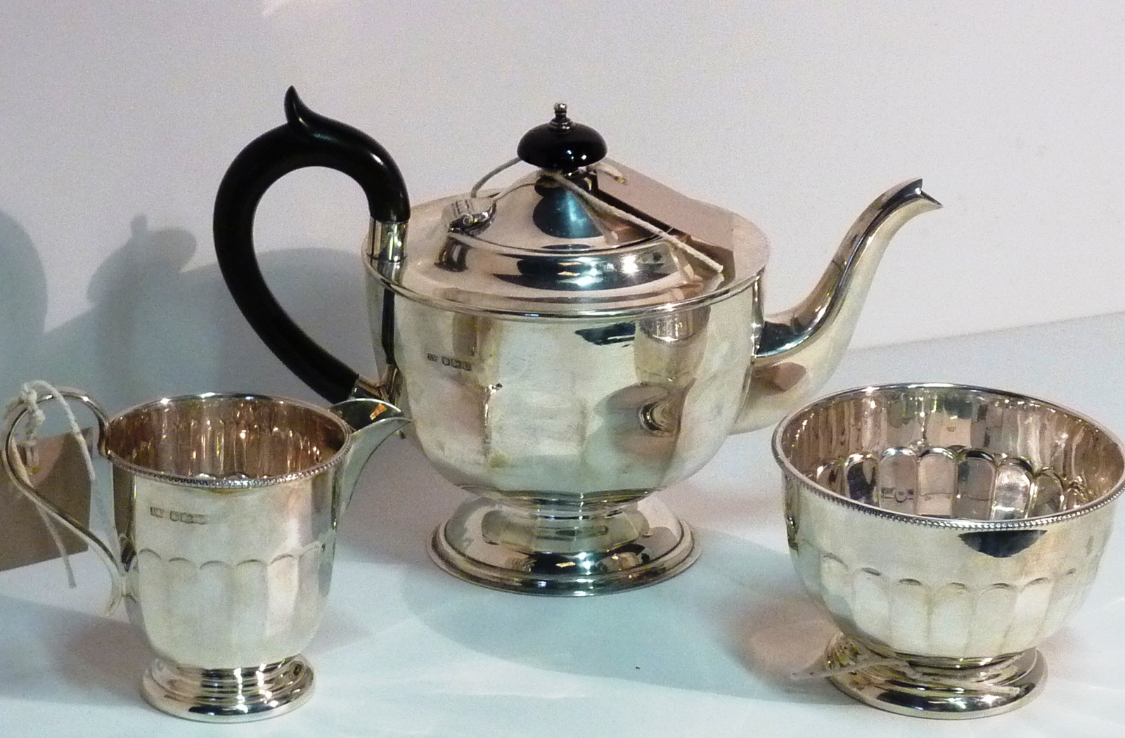 A three piece hallmarked silver 1930's Tea Service comprising Tea Pot, Milk Jug and circular Sugar
