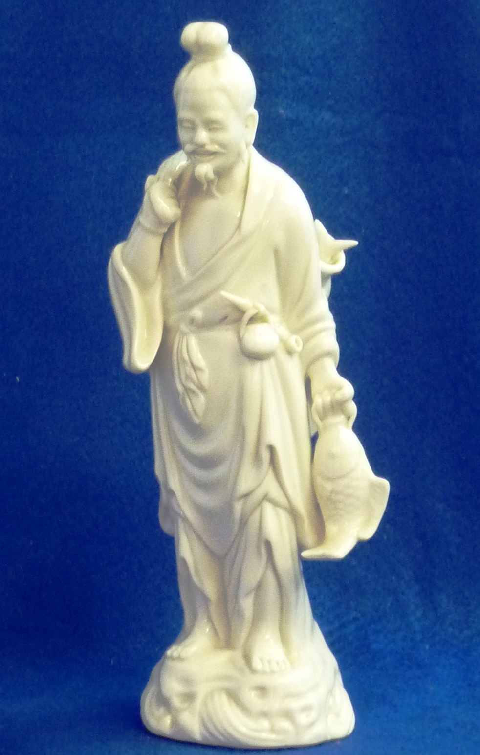 20th century Chinese Blanc de Chine figure of a Fisherman, Height 26.5 cms.