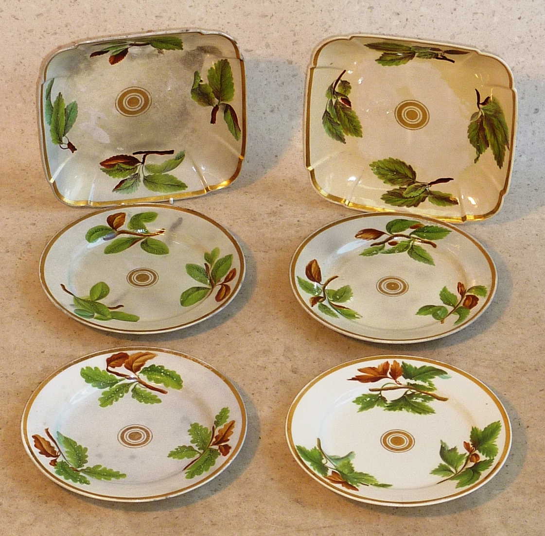 A pair of early 19th Century square Dishes each with central concentric gilded circular motifs