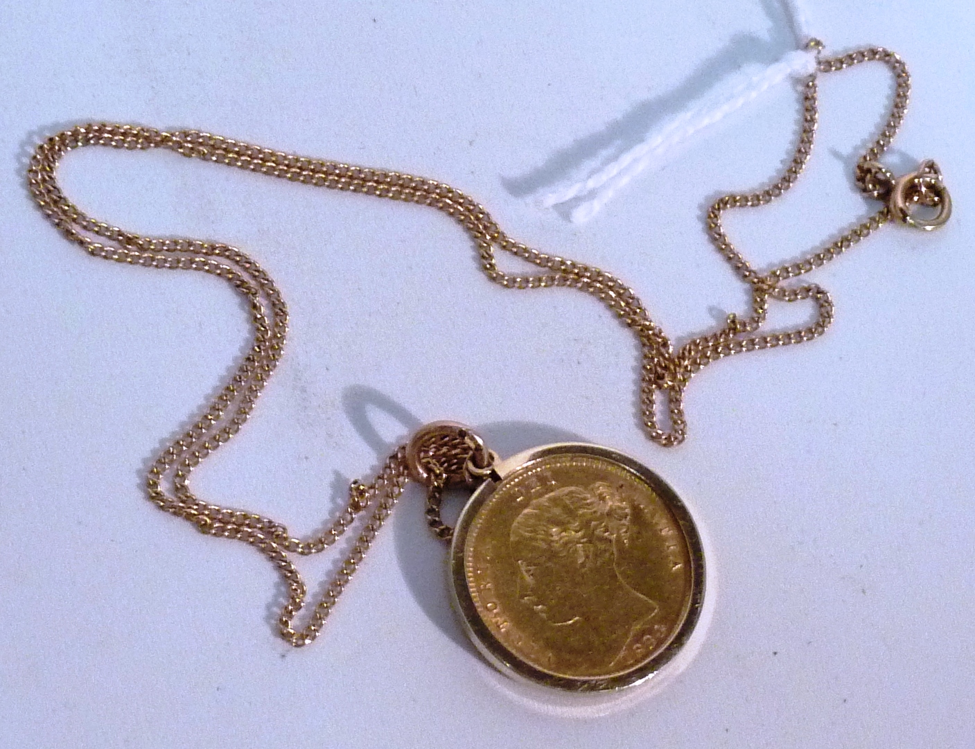 A Victorian mounted Half Sovereign and 9 carat Chain