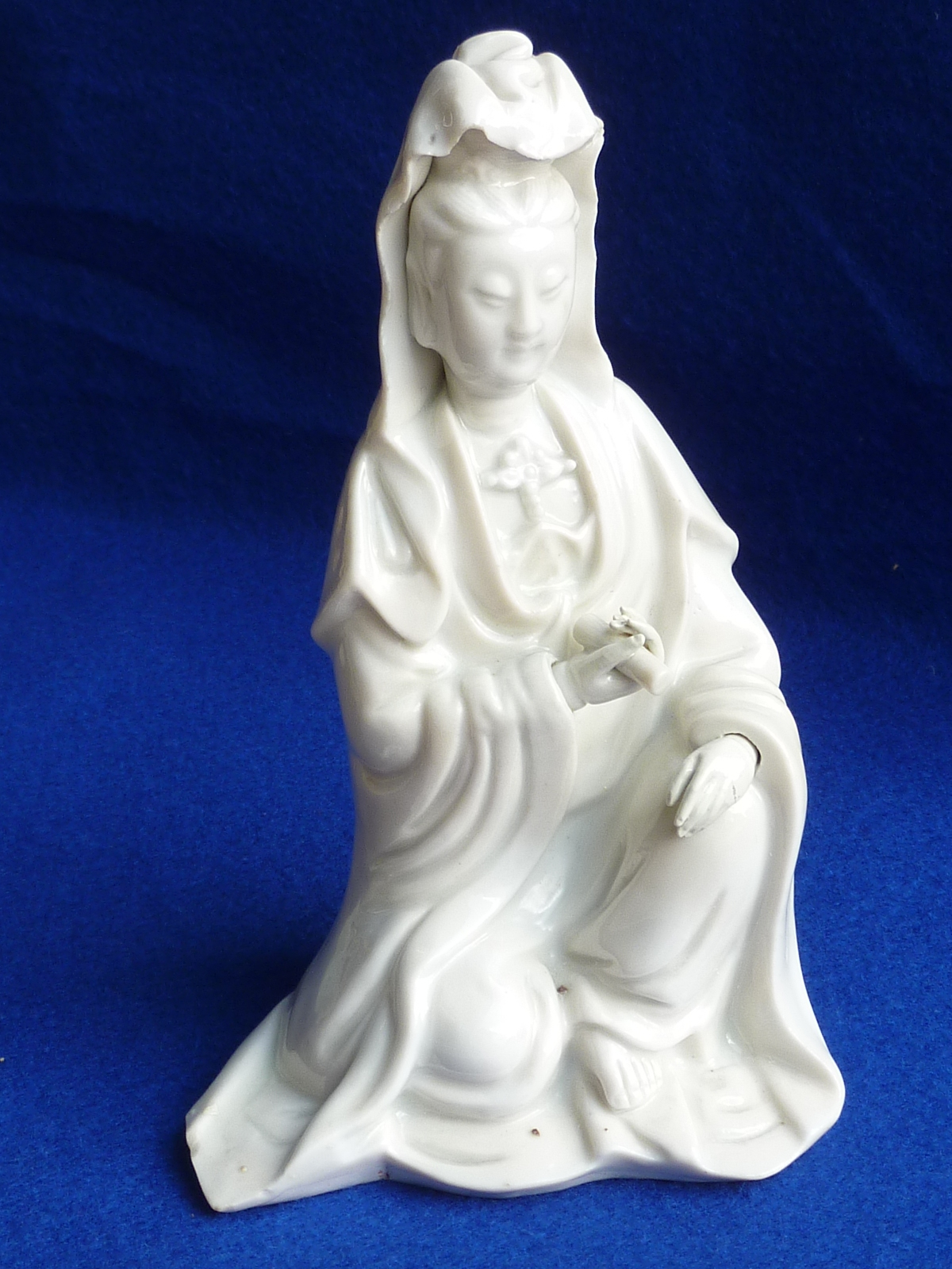 A 17th Century Chinese Blanc de Chine model of a kneeling Guanyin (Chinese Goddess of Mercy) with