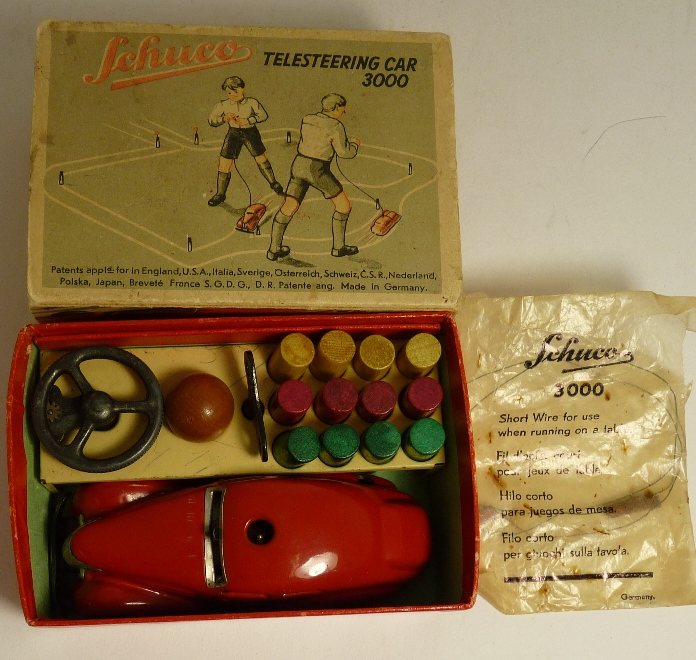 Schuco Telesteering Car 3000, the red car in box complete with ball, key, steering wheel ,