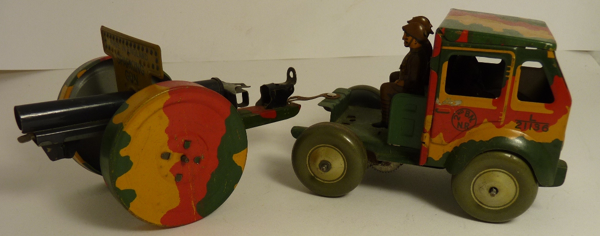 An English made tinplate clockwork Army lorry towing a "Sparking Gun" field gun, red/green/ochre