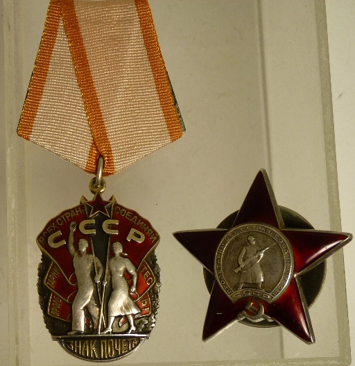 A Russian Order of the Red Star medal with screw off disc to the back and engraved number together