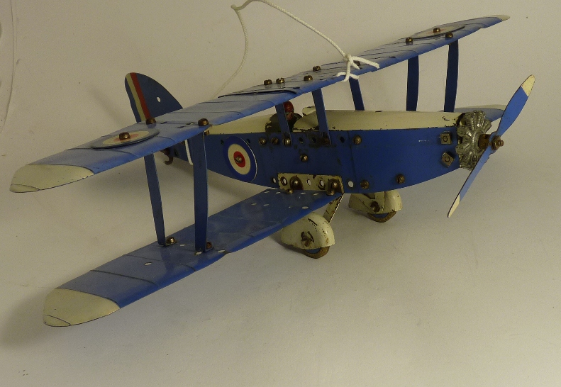 A constructed Meccano single engine bi-plane, blue and white with RAF roundels and green pilot