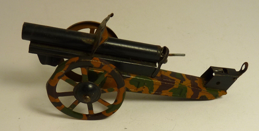 A German made tinplate field gun with camouflage detail, 15cms long