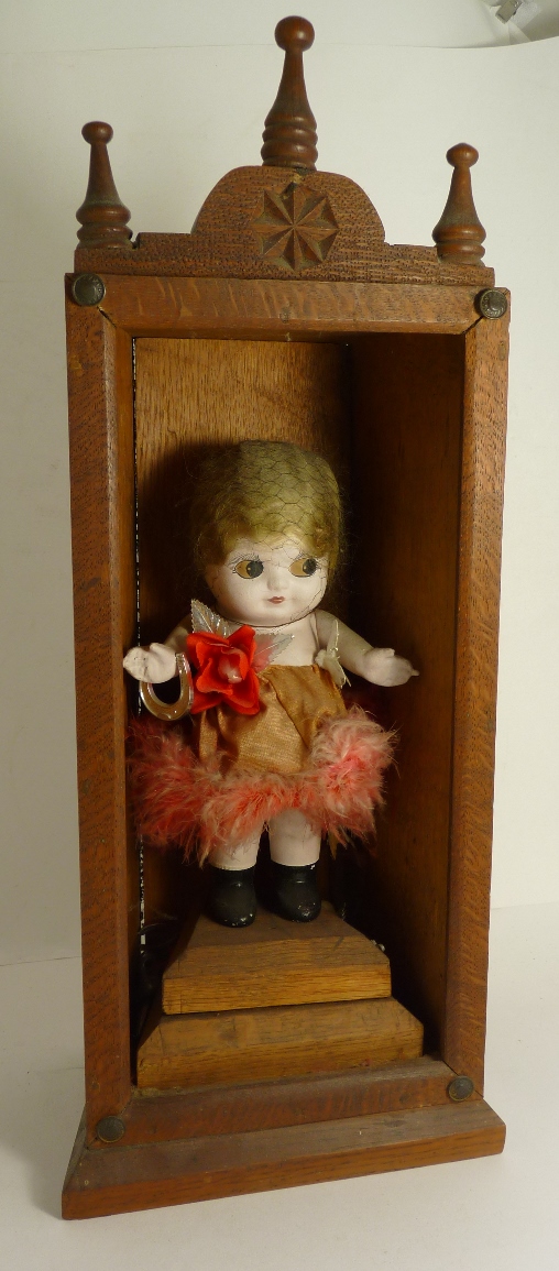 An early 20th Century painted composition doll with blond hair, sideways glancing eyes, wearing