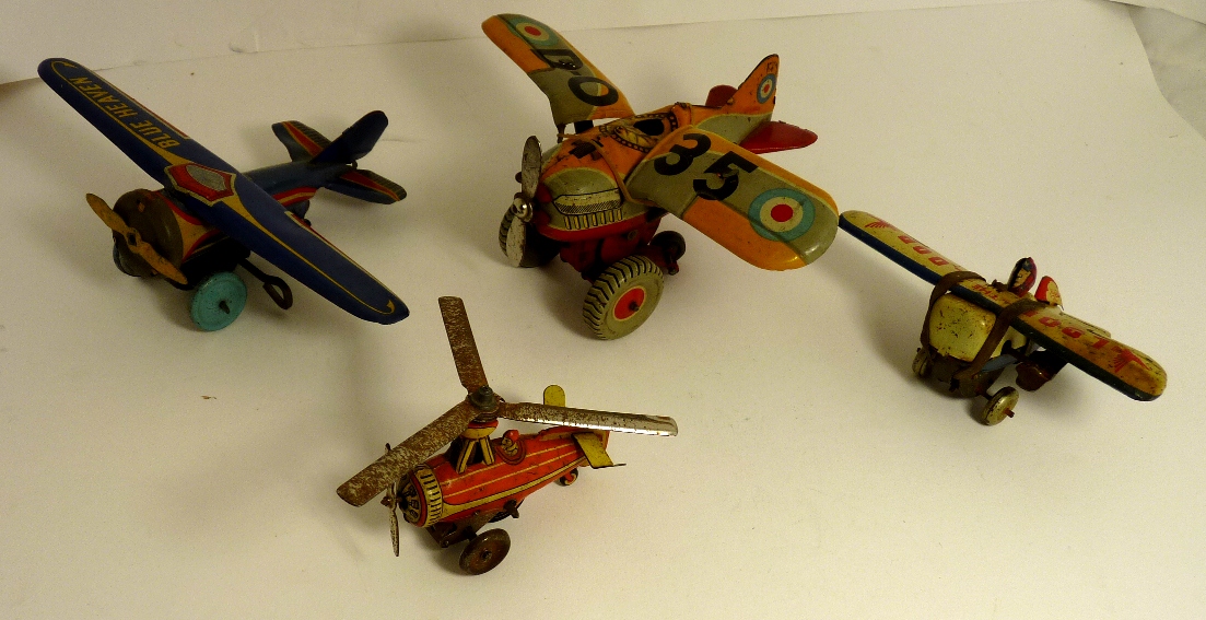 A Japanese made tinplate clockwork Loop-The-Loop aeroplane with pilot; a "Blue Heaven" tinplate