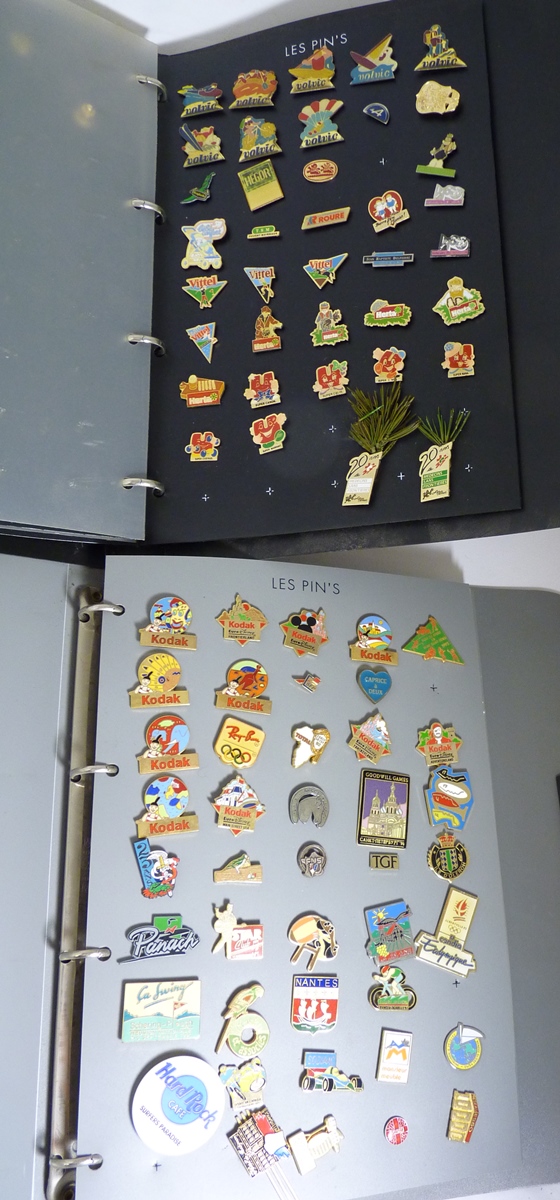 A collection of 20th Century advertising lapel pins, many different including Kodak, Volvic and