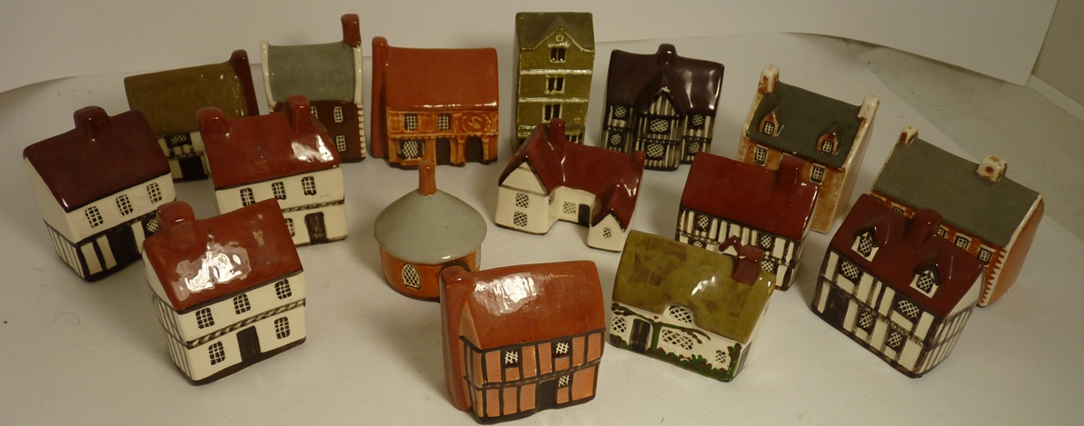 A collection of sixteen miniature glazed ceramic houses by Mudlen End Studio, Felsham Suffolk