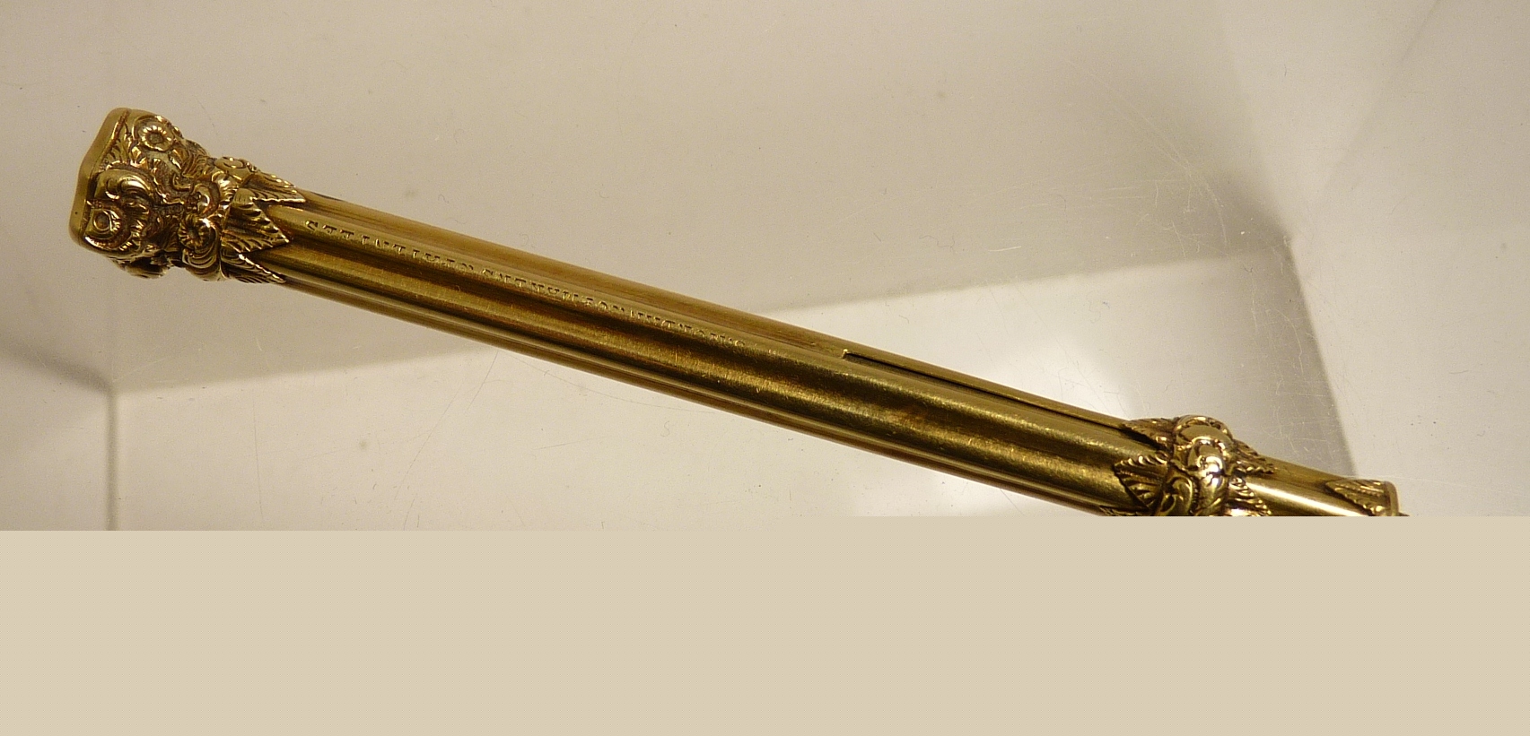 A Victorian gold propelling pencil by Mordan, the ribbed case with floral slider and end set with