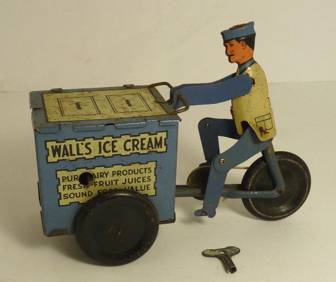 A tinplate clockwork Walls Ice Cream vendor on trike, blue white and black printed detail, with key,