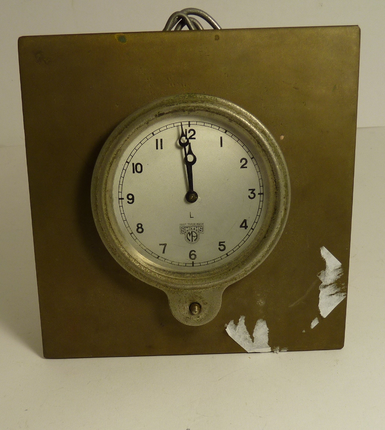 A Smiths dashboard timepiece in metal surround, 9cms diam