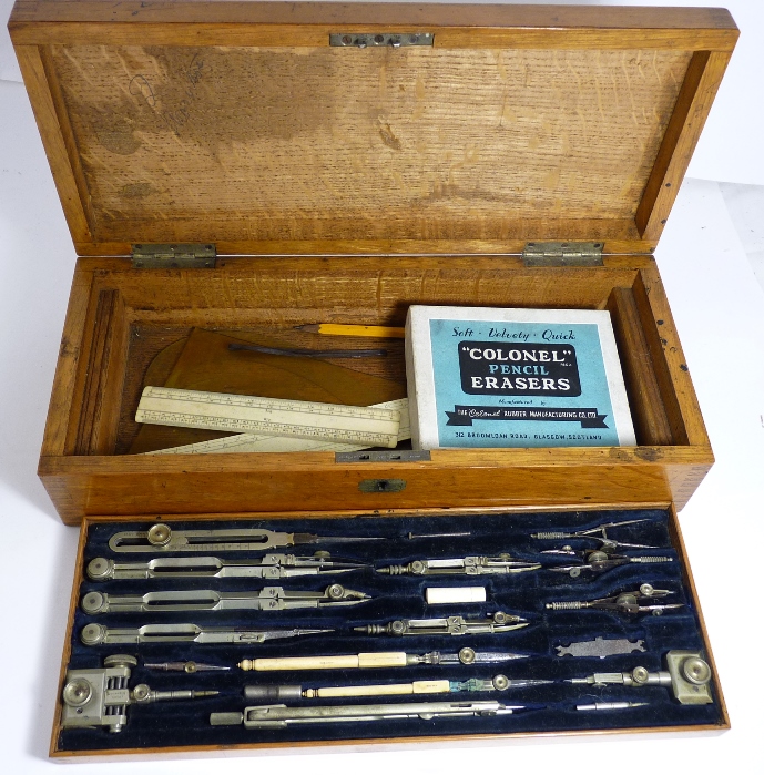 An early 20th Century oak cased set of draughtsmans instruments, having fitted lift-out tray of