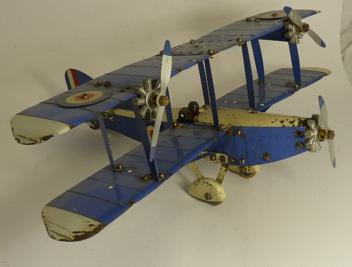 A constructed Meccano three engine bi-plane, blue and white with RAF roundels and red pilot