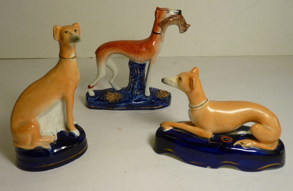 A Staffordshire pottery Greyhound pen holder; a Staffordshire figure of a seated Greyhound and