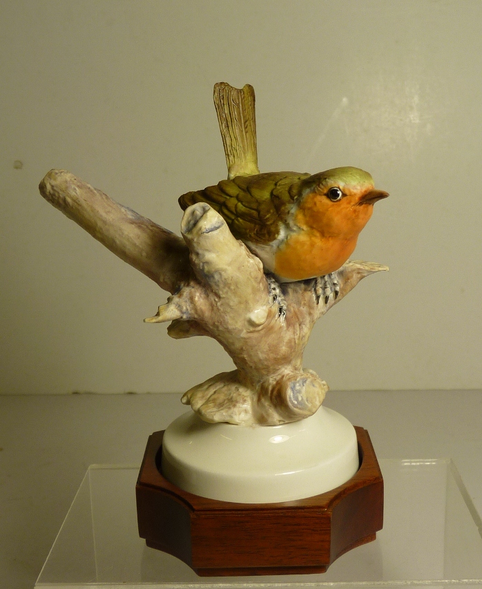 An Albany Fine China Limited edition porcelain Robin perched on a branch by David Burnham Smith,