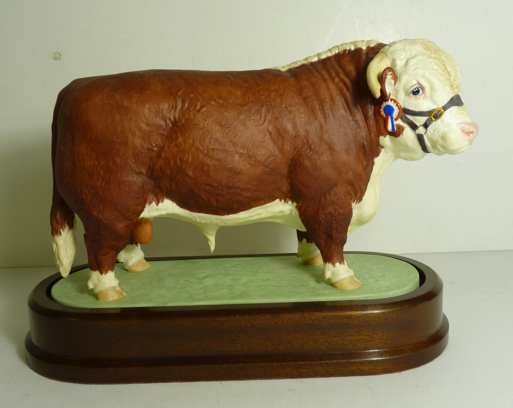 A Royal Worcester porcelain model of a Hereford Bull by Doris Lindner, on wood base and with