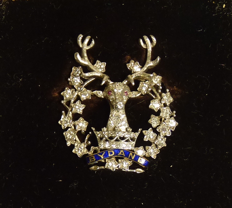 Gordon Highlanders - a diamond and ruby set regimental brooch, the stags head with ruby eyes,