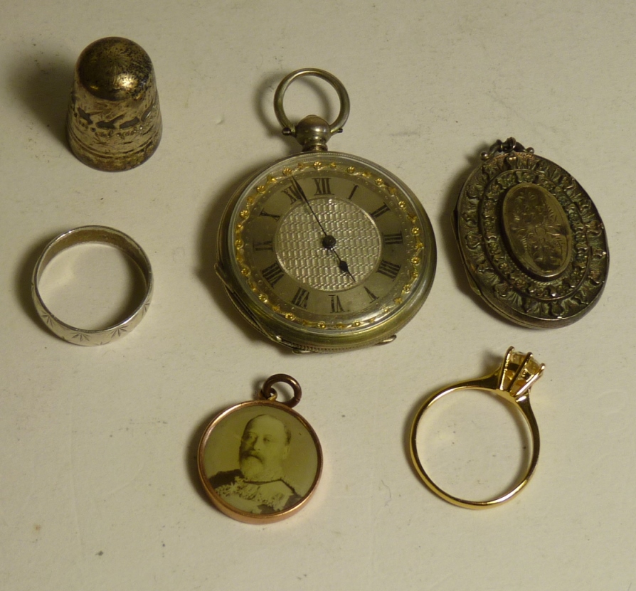 A decorative silver metal cased open face pocket watch; a Victorian silver locket, a Dorcas