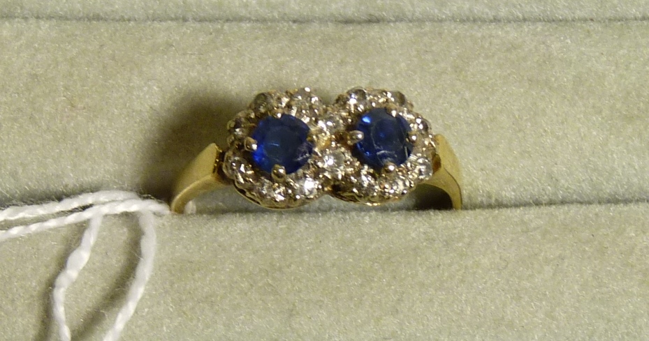 A 18ct gold two stone sapphire and diamond ring