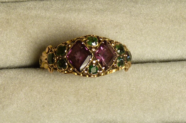 A Victorian 15ct gold ring set with lozenge shaped amethysts and green stones (peridots?) with