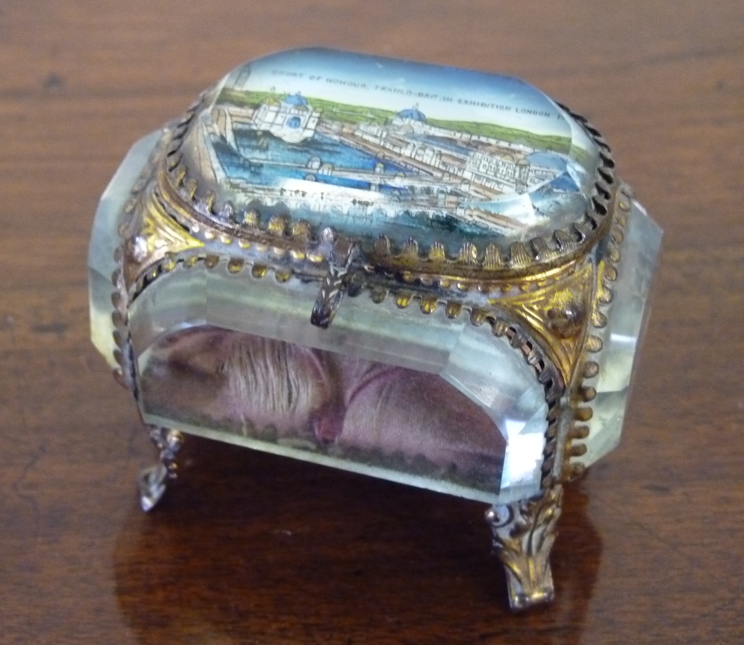 A souvenir Continental glass and gilt metal casket type trinket box, the lid with colourful image of