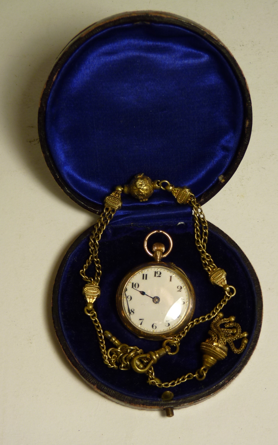 A lady`s 9ct gold cased open face fob watch having white enamel dial (af), cylinder escapement and