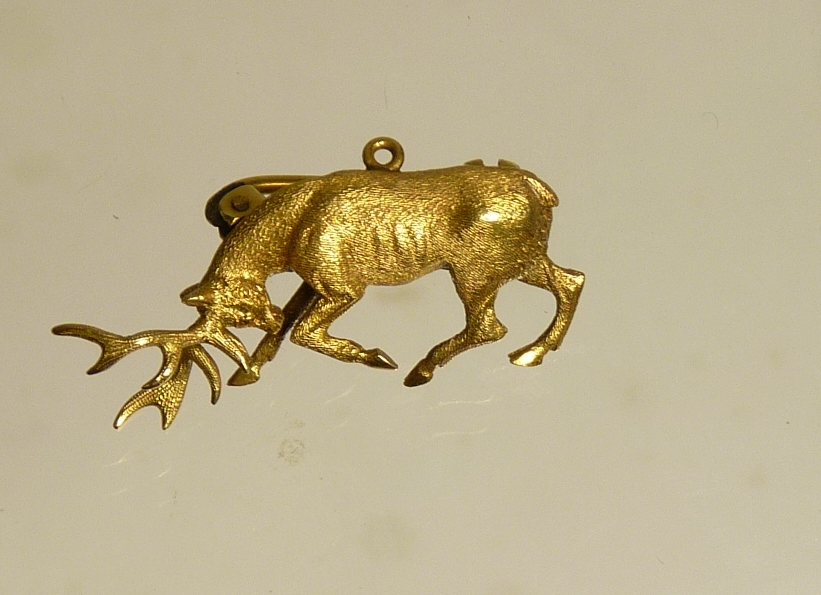 A gold brooch naturalistically modelled as a Red Deer stag with head down (unmarked but tests as