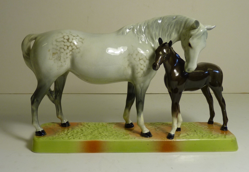 A Beswick figure of a dapple grey mare and bay foal on a rectangular base, impressed "1811" ,