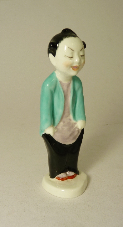 A Royal Worcester porcelain figure of a Chinese boy wearing turquoise jacket and black trousers,