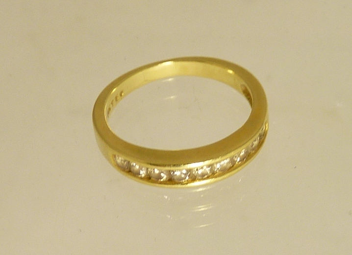 An 18ct gold diamond set half-eternity ring, size L.