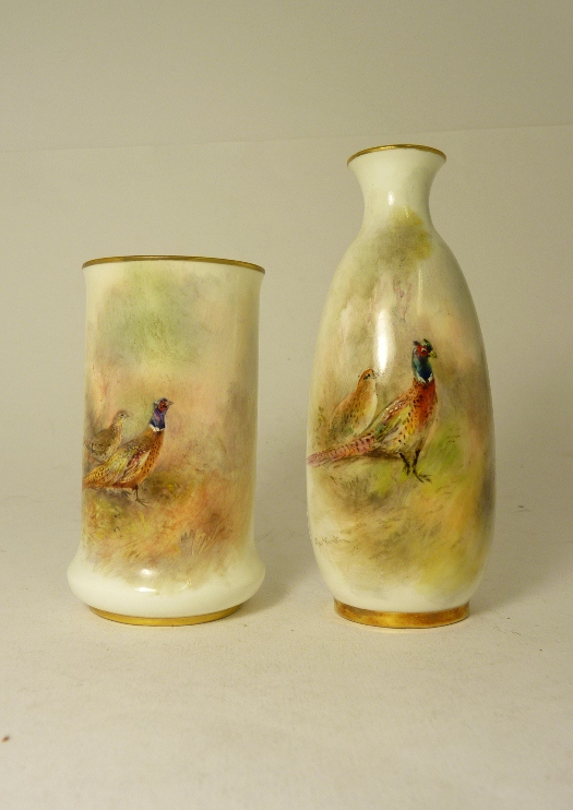 A small Royal Worcester porcelain vase of cylindrical form, painted with a cock and hen pheasant