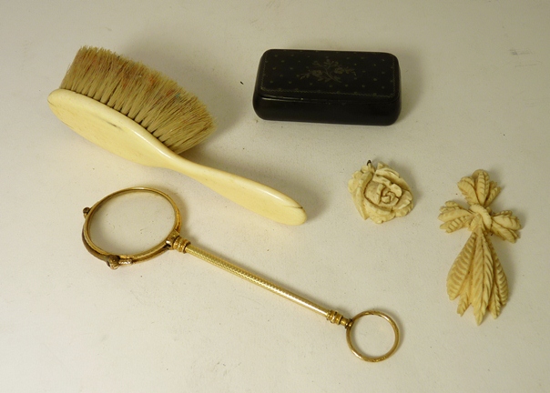 A Victorian gilt metal lorgnette; a 19th Century papier mache snuff box; a child`s ivory-backed hair