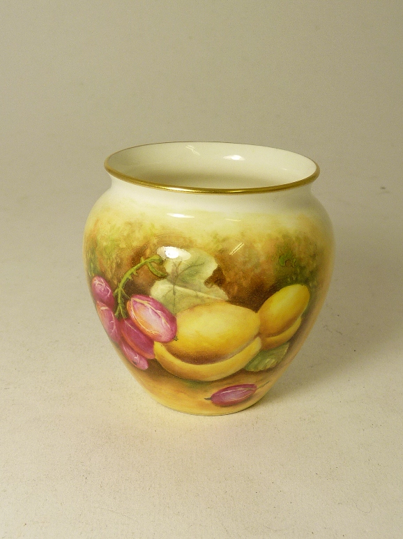 A small Royal Worcester porcelain vase painted with fruit on a white ground by D. Bowket, black