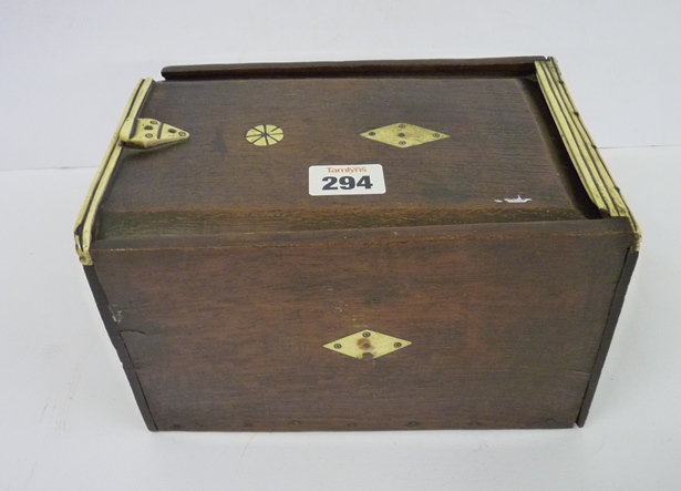 A 19th Century simply-made oak box with sliding lid and divided interior, with ivory edging to lid