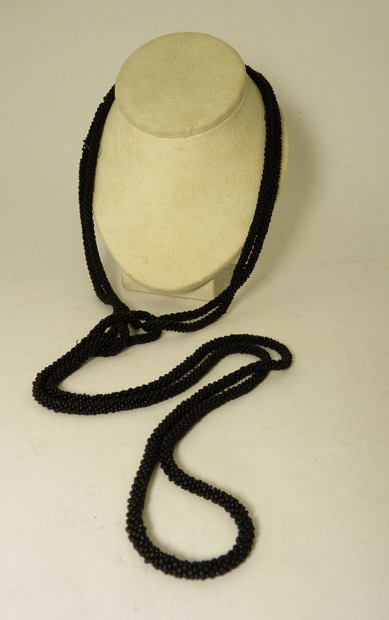A Victorian black bead mourning necklace of rope form and jet bead and circle decoration (af).