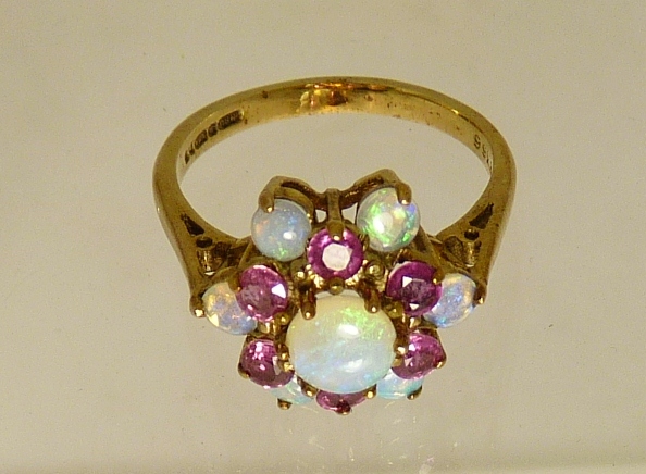 A ladies 9ct gold dress ring, the ring of flowerhead form and set with a central circular