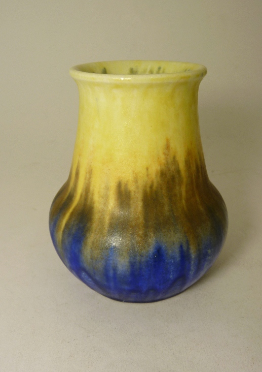 A Ruskin pottery vase of squat baluster form in cream/blue glaze, impressed factory marks and date