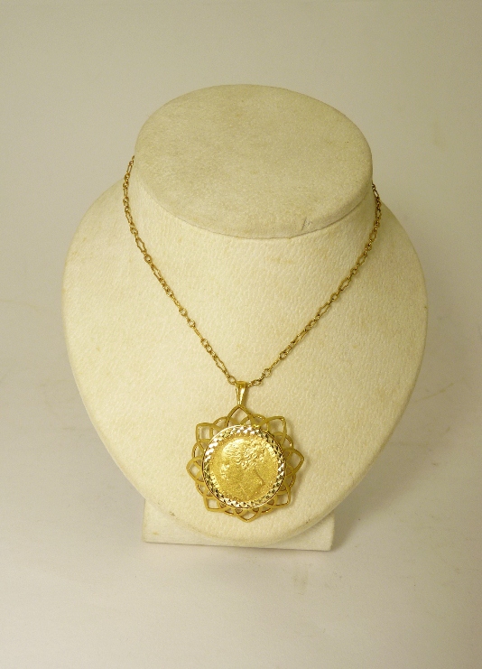 A sovereign pendant in a 9ct gold clip mount, the sovereign dated c.1879 with the head of young