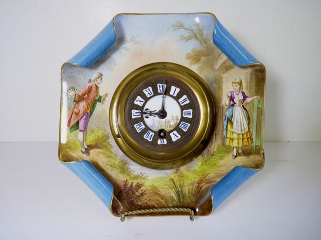 A 19th Century ceramic wall timepiece, the circular brass case with raised painted porcelain