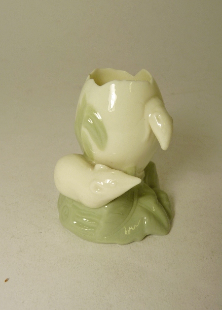 A Royal Worcester porcelain vase modelled as rats with an egg shell, pastel green and cream glaze,