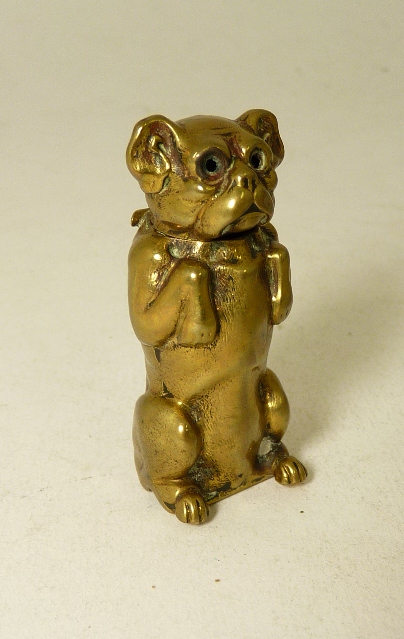 A late 19th Century novelty brass vesta case in the form of a begging dog, 5.5cm approx.