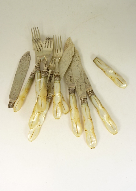 Carved mother of pearl handled and silver bladed fish knives and forks, (six forks and five knives).