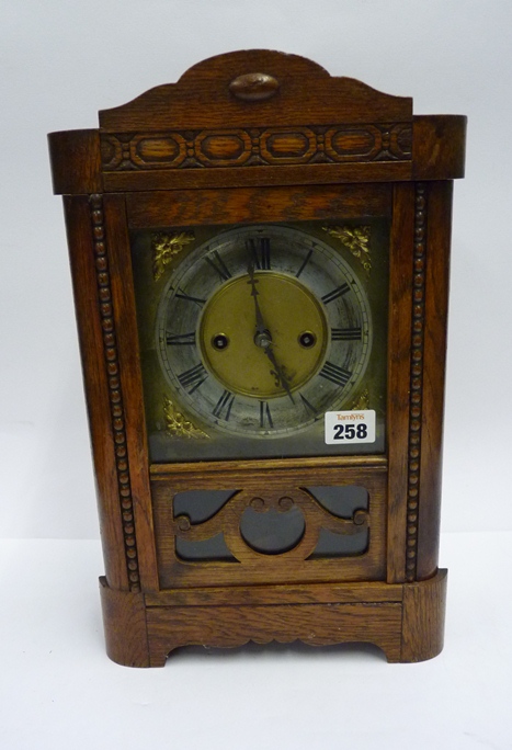 An oak and beech cased mantle clock, the movement striking on a gong, the dial with black Roman