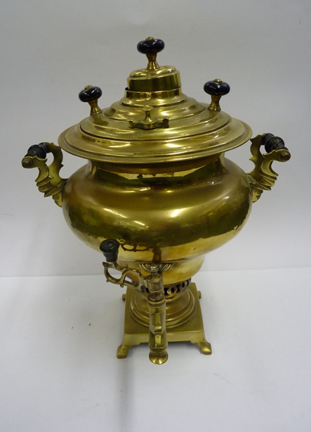 A Russian brass samovar with ebonised handles and mounts and with original receipt.