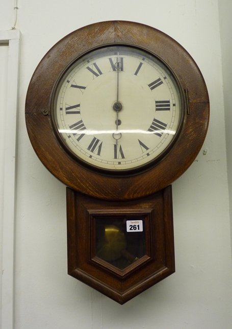 A stained beech drop dial wall clock with painted white tin dial with black Roman numerals and cut