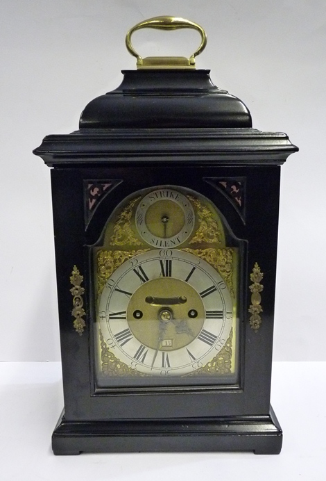 A George II ebonised bracket clock with 1/4 repeat c.1740; the 14.5 cm broken arch brass dial with
